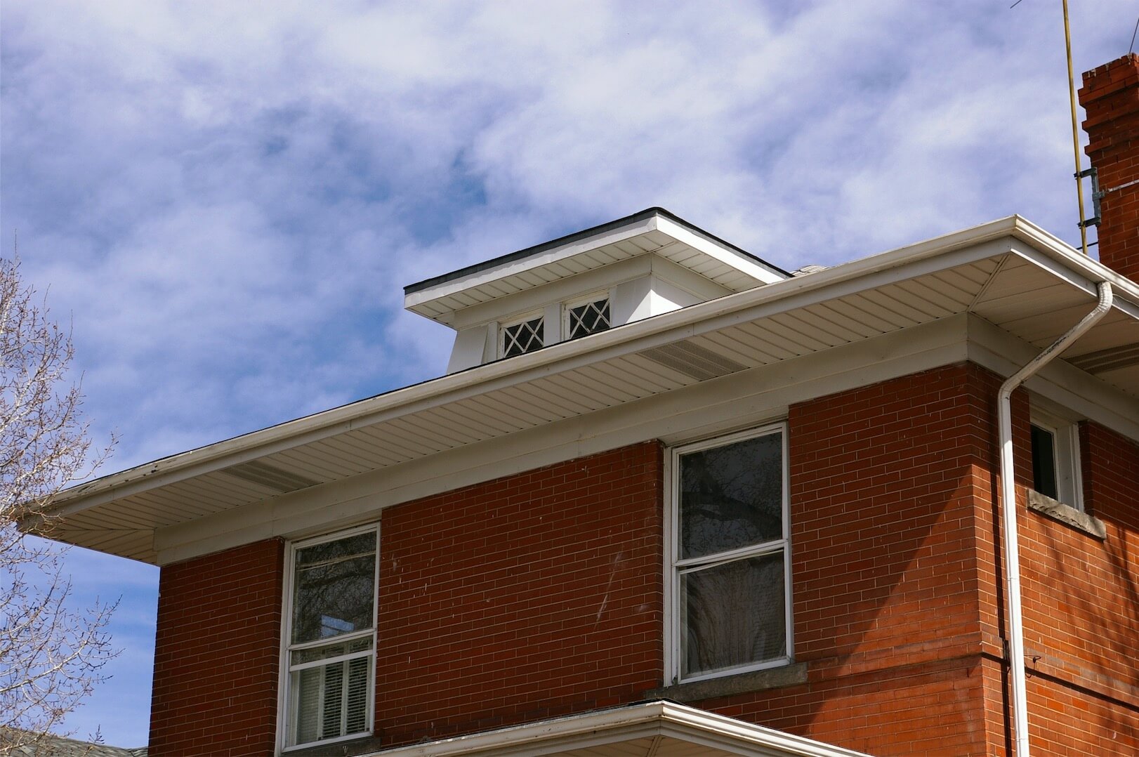 Red brick home with white trim