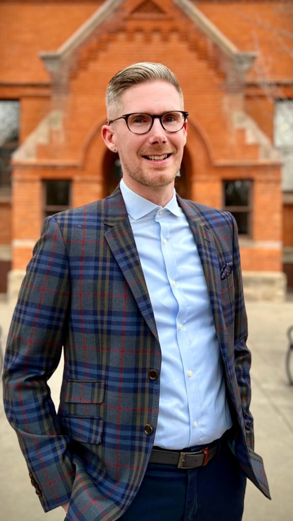 a man, john deffenbaugh, standing in front of historic building