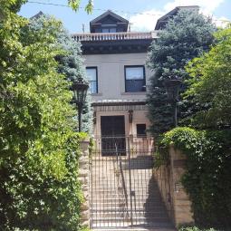 a tree in front of a house