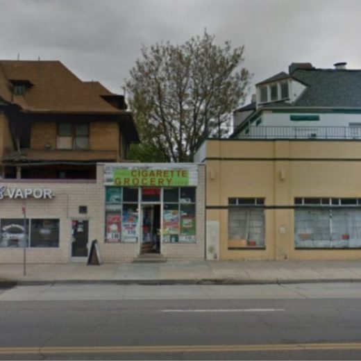 a building that has a sign on the side of a road