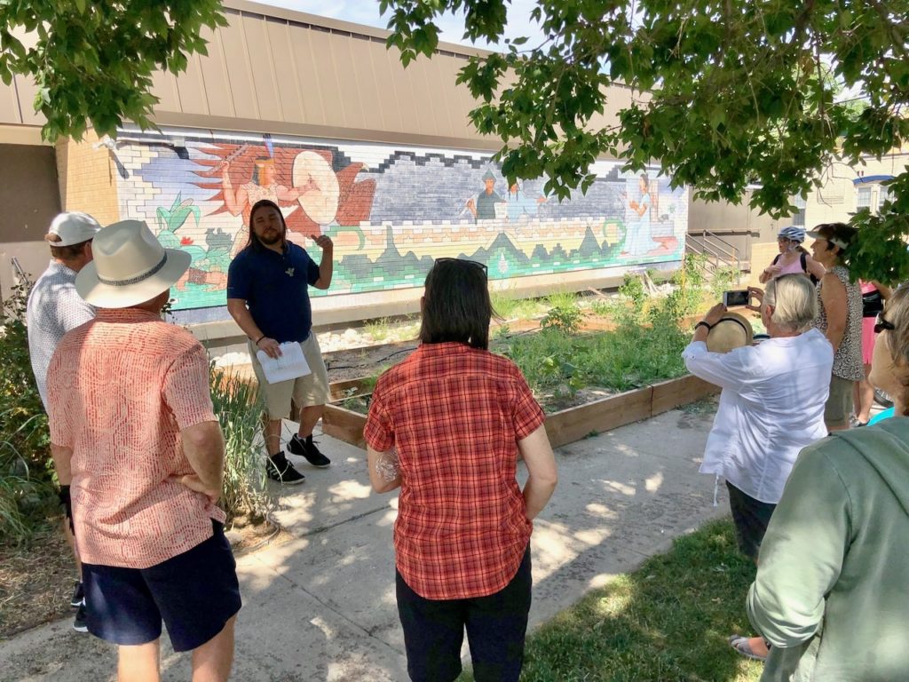 Ean-Murals-1024×768 a group of people standing in a park