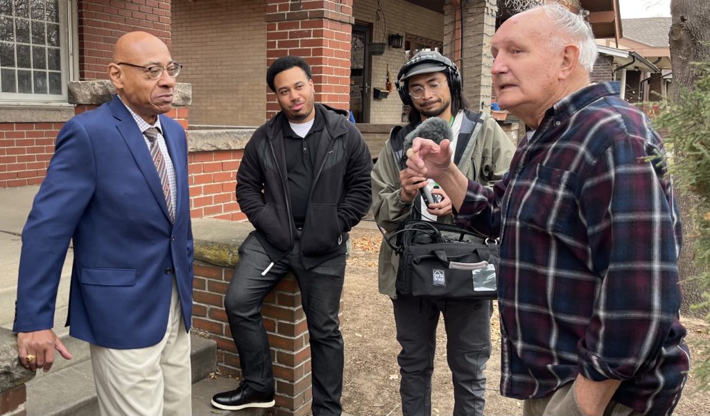 Judge-Raymond-Jones-Greeting-Former-Neighbors-1024×601 a group of people standing together in uniform