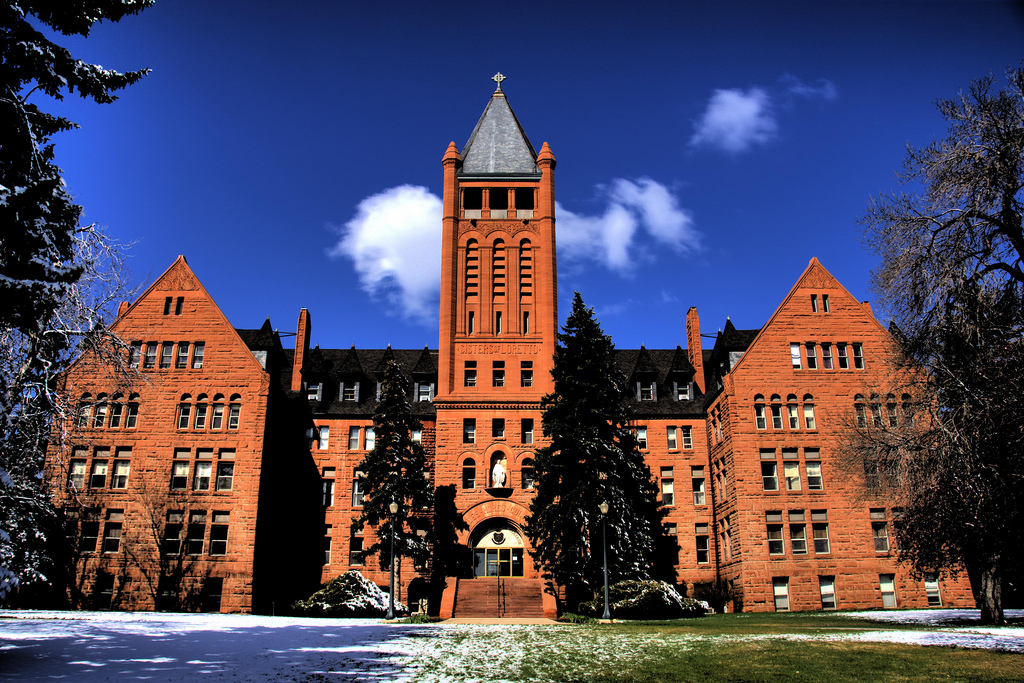 Loretto-Heights-Main-Campus a large brick building with a clock tower