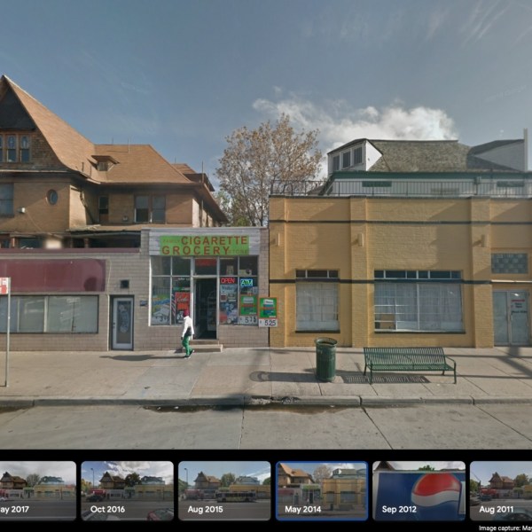 a building that has a sign on the side of a road