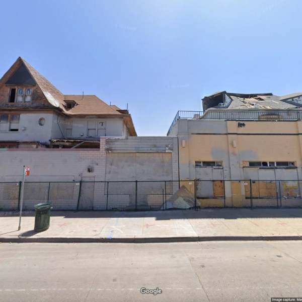 a building that has a sign on the side of a road