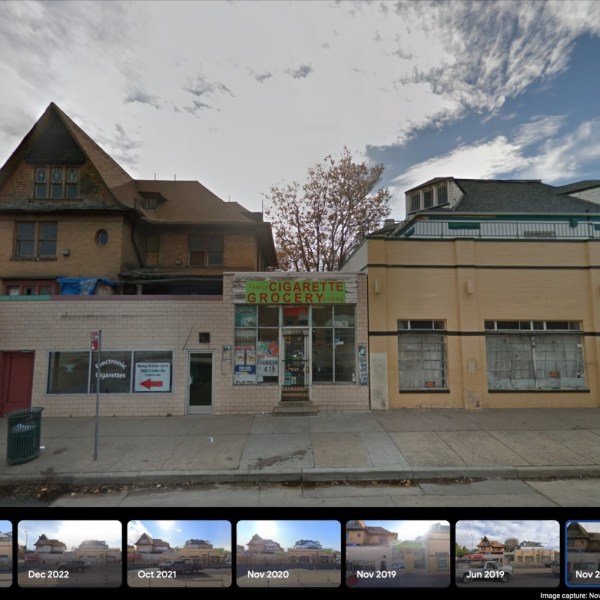 a building that has a sign on the side of a road