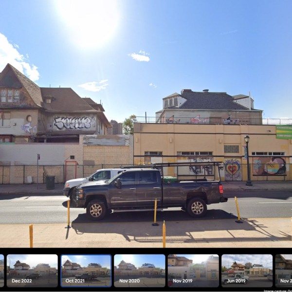 a truck that has a sign on the side of a road