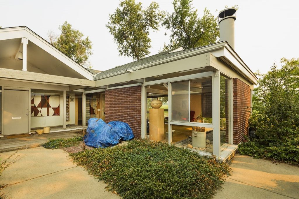 henderson-1024×683 a person standing in front of a house