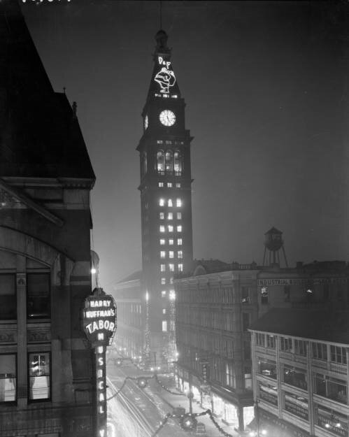 a clock tower in the middle of a city at night