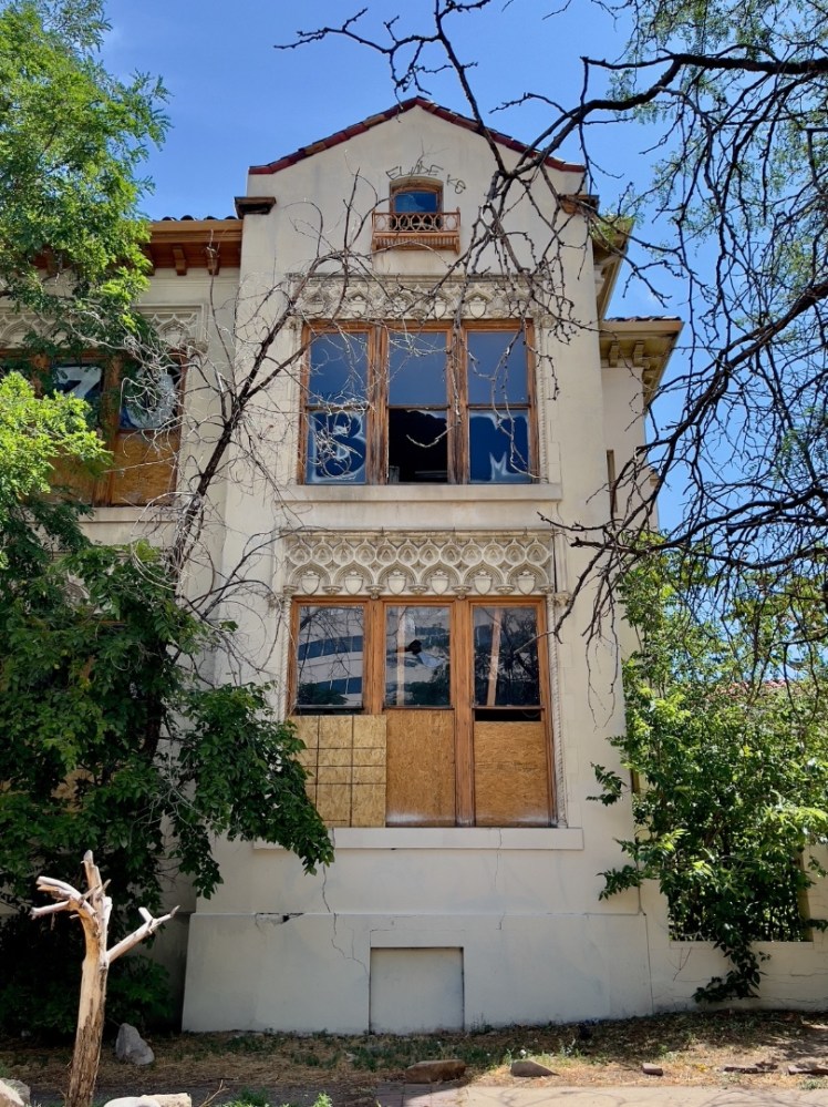 a house with bushes in front of a building