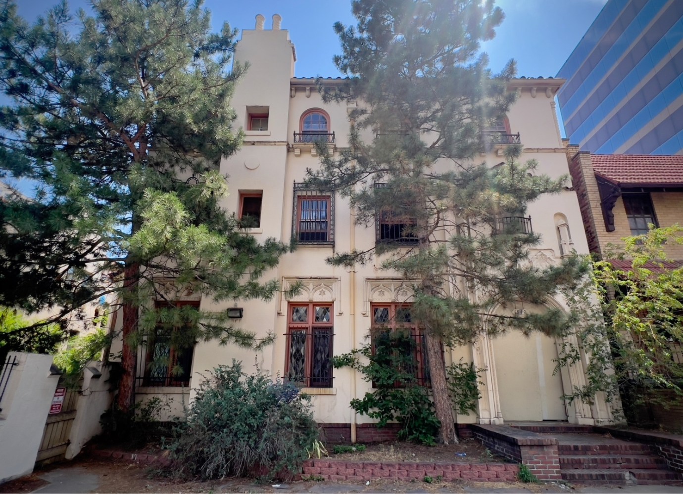 a house with bushes in front of a building