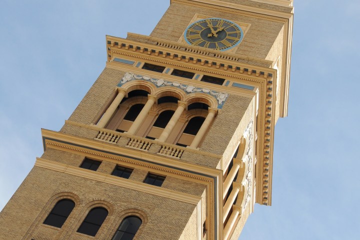 a large tall tower with a clock at the top of a building