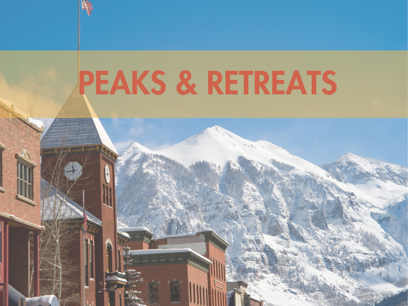 Snow-covered mountains behind a snowy town with a clock tower. Text reads 'Peaks & Retreats'.