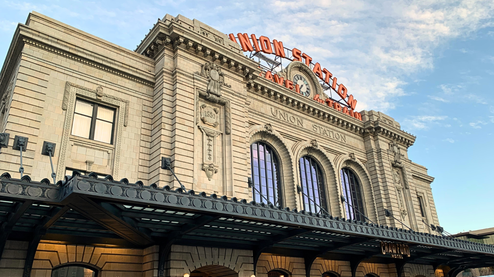 Historic train station with 'Union Station' sign under a blue sky.